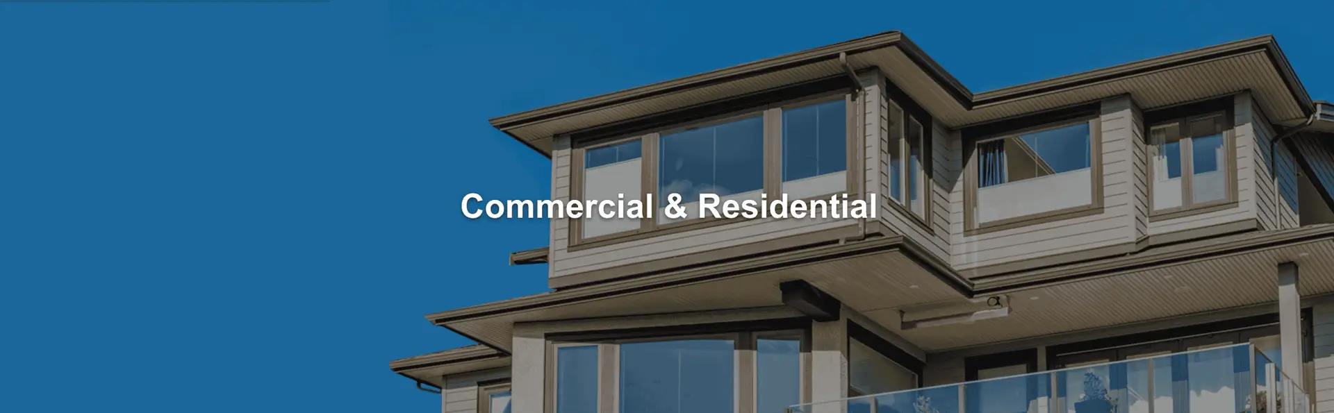 Modern two-story home with gutters along the roofline and the words Commercial & Residential.